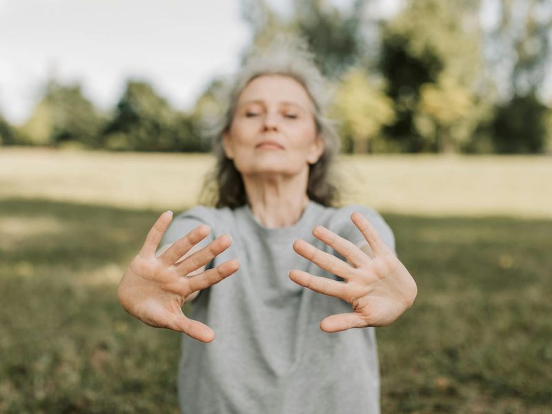 Close up of a yoga practitioner's hands moving gracefully.