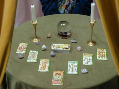 Crystals and a candle on a small meditation table.